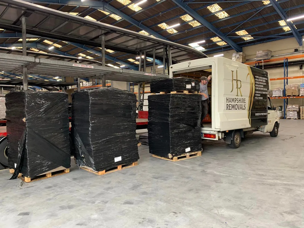 Boxes and plastic containers stacked high, ready for moving