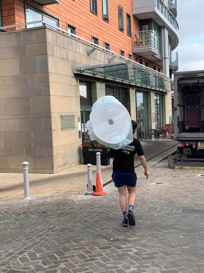 Items being carried up a spiral staircase