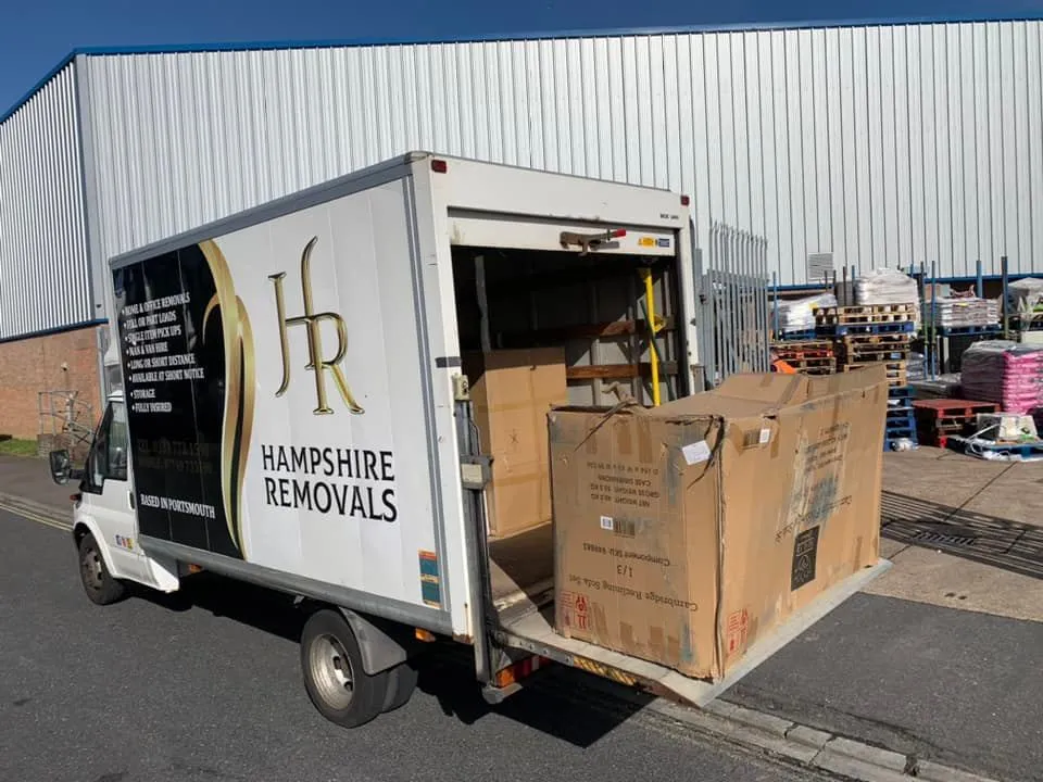 Boxes being moved from one room to another by an employee